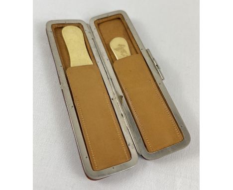 A vintage soft leather and chrome clip case containing two bone page turners. Approx. 14 cm long. 