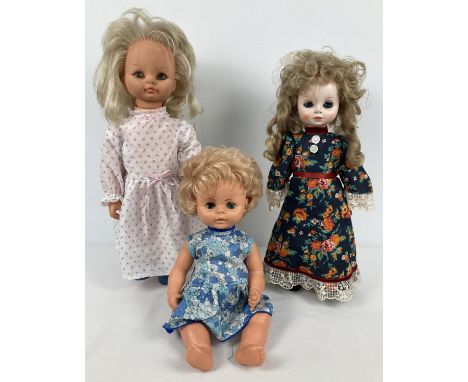 3 vintage vinyl dolls. A baby doll by Chiltern with closing eyes and blue floral dress, a Katie Copycat doll with blonde hair