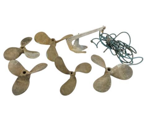 Five various bronze boat propellers - together with a claw anchor. (6)
