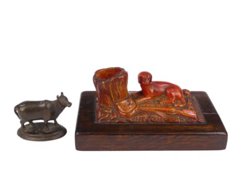 A 19th century bronze - modelled as a cow, raised on a oval base, 5cm wide, together with a paperweight, modelled as a huntin