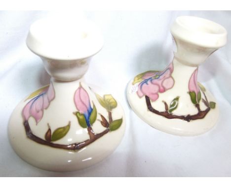PAIR OF MOORCROFT CANDLESTICKS. Pair of Moorcroft Pink Magnolia squat candle sticks 