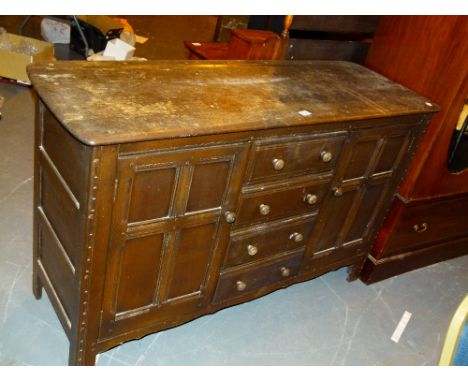 ERCOL SIDEBOARD. Ercol sideboard with two cupboards flanking four central drawers, W: 144 cm