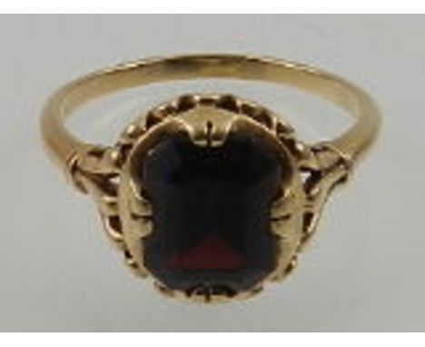 A 9 carat yellow gold and garnet ring.