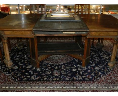 An early 19th century continental walnut extending dining table, the rectangular top with canted corners above a carved friez