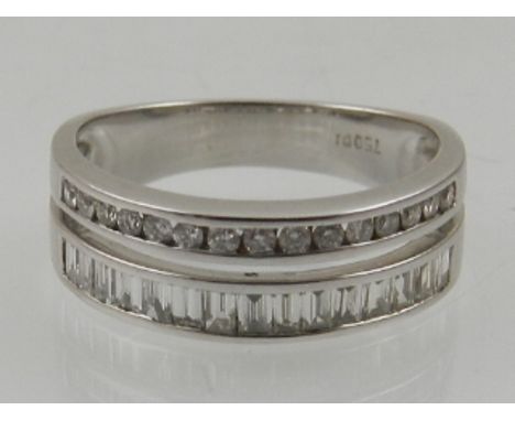 An 18 carat white gold and diamond double band half eternity ring, set a line of baguette cut diamonds, and a line of channel