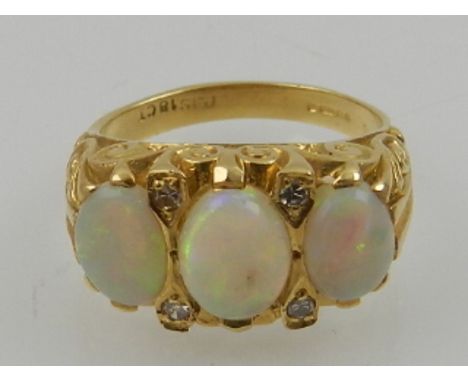 An 18 carat yellow gold, opal and diamond set dress ring.