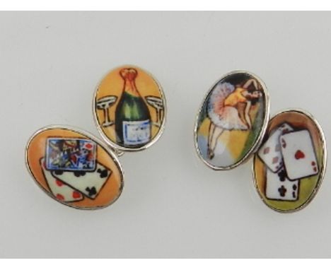A pair of silver and enamel cuff links, of oval design, bearing images of cards and champagne bottles. 