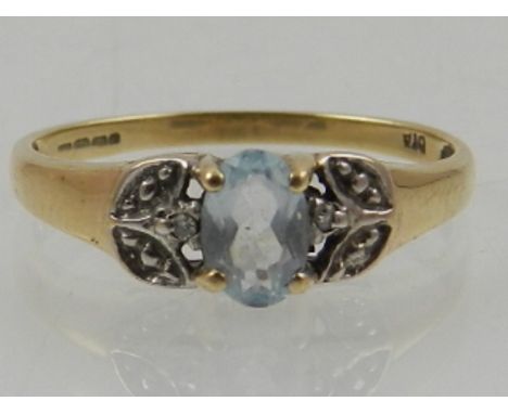 A 9 carat yellow gold and aquamarine ring, set oval cut aquamarine in white metal reserves. 
