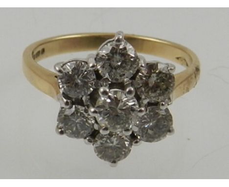 A 9 carat yellow gold and diamond floral cluster ring, the stones of approx. 1.75 carats. 