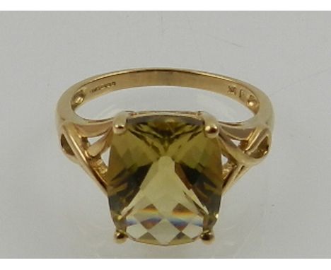 A 9 carat yellow gold and faceted peridot cocktail ring. 