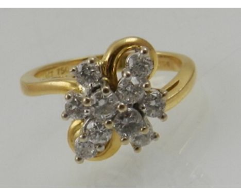 An 18 carat yellow gold and diamond cluster ring, set ten round cut diamonds.