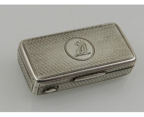 A silver vesta case, London 1860, of  rectangular engine turned form, the lid incorporating a family crest and gilded interio