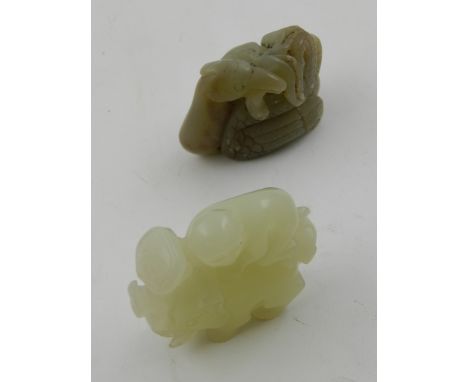 A carved jade paperweight in the form of a money and elephant, H. 5cm, together with another jade paperweight, (2).
