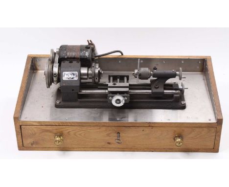 1960s Emco Unimat SL tabletop lathe, housed on a oak custom-made cabinet with a lockable drawer containing machine vice, face