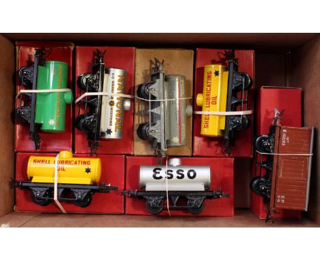 Six Hornby tank wagons with one goods van, all post-war, none is No.50 style: One each Manchester Oil; National; Pool, Esso a