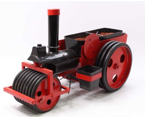 A scratch built garden planter in the form of a live steam roller traction engine handpainted in red and black and built by P