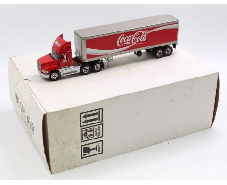 A Franklin Mint 1/43 scale diecast model of a Mack Coca Cola delivery tractor unit and trailer housed in the original polysty