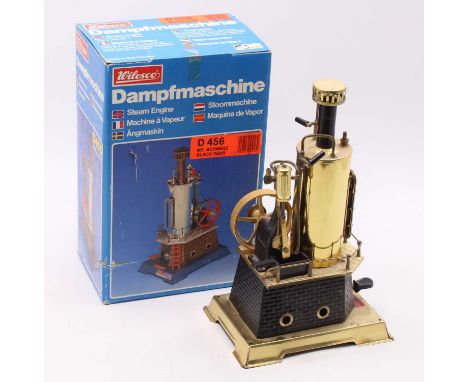a Wilesco D456 vertical steam engine in black and brass, with burner, sight glass, steam whistle and safety valve, very littl