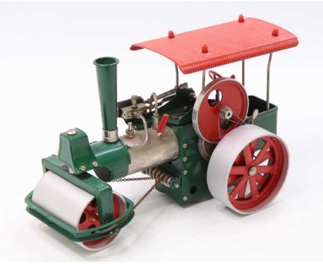 A Wilesco Old Smoky live steam traction engine comprising of green body with red canopy fitted with can motor to rear to powe