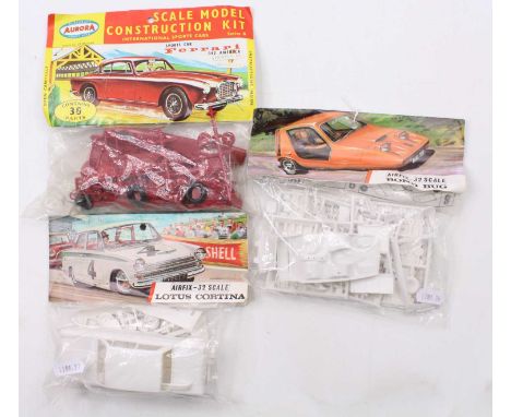 A collection of three bagged Airfix and Aurora 1/32 scale plastic kits to include an Airfix Lotus Cortina, an Aurora Ferrari 