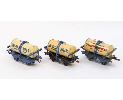 Three Hornby 0-gauge Milk tank wagons: 1933-4 United Dairies, white tank, lighter blue base, with drain cocks (G); 1936-9 Nes