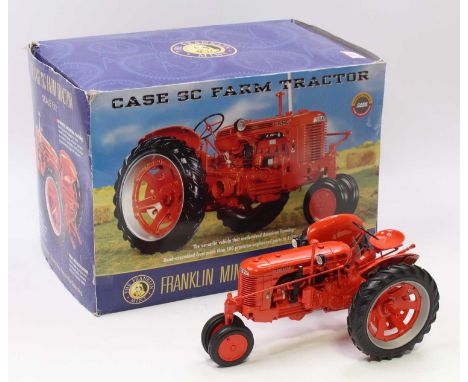 A Franklin Mint 1/12 scale diecast model of a Case SC Farm Tractor finished in orange and housed in the original but heavily 
