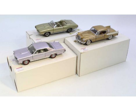 A collection of three Danbury Mi9nt 1/24 scale diecast vehicles to include a 1957 Studebaker, a 1965 Pontiac GTO, and a 1968 