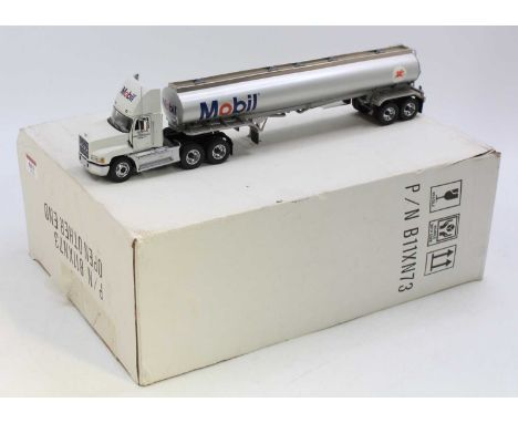 A Franklin Mint 1/43 diecast model of the Ultimate Mobil Mack Tractor Unit and Tanker Trailer, comprising white cab with silv