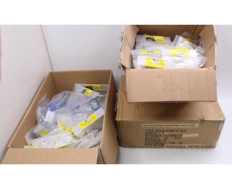 Three boxes containing a quantity of various De Agostini Valentino Rossi 1/4 scale factory issued spare parts and components,