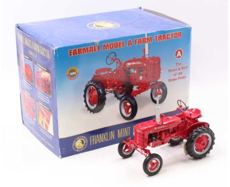 A Franklin Mint 1/12 scale diecast model of a Farmall model A farm tractor, finished in red and housed in the original packag