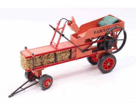 A scratch built Ransomes vintage baler, handpainted in two-tone red with working Lego Technic mechanism, complete with rubber