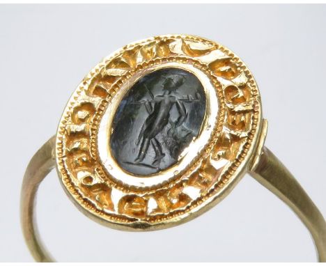 Medieval Gold Seal Ring. Circa, 13th century AD. Gold, 3.9 grams. 21mm, bezel, 16mm. A circular band with large oval bezel se