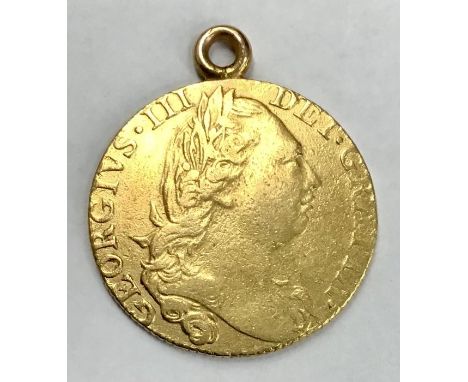 A George III 1776 gold guinea, soldered suspension ring. total weight 8.4 grams  WORN