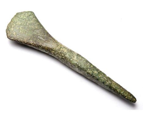 Small Bronze Age Chisel.  Circa, 1150-800 BC. Copper-alloy, 27.82 g, 83.79 mm. formed of a long square sectioned tang that ta