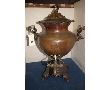 *A 19th Century copper samovar, the top with greyhound head finial, two handles in the form of stags heads, ceramic insulated
