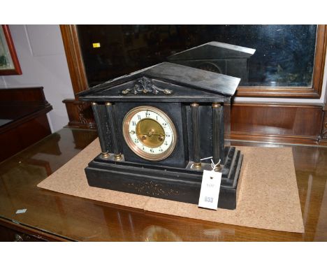 A mantel clock in slate case, of temple form.