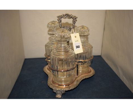 *A Sheffield plated decanter stand; and three associated glass decanters.