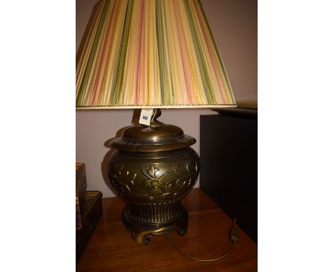 A modern lacquered brass table lamp with fluted and floral decoration.