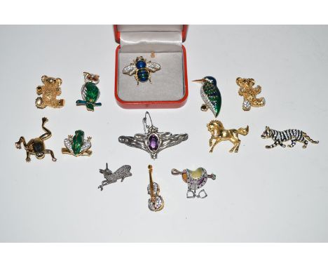 A large quantity of brooches, including: a white metal, enamel and marcasite saddle pattern brooch; and a white metal Art Nou