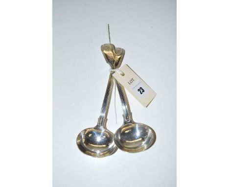 A pair of silver sauce ladles in Kings shell pattern, by M.C., London 1836, engraved shield to finial.