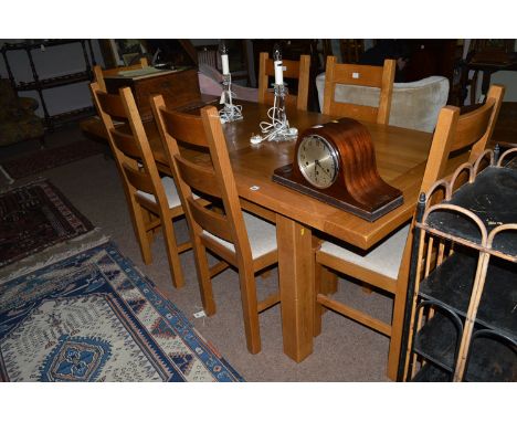 A light stained oak modern draw leaf dining table; together with six chairs.
