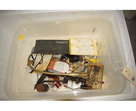 A collection of fly tying tools and implements, including: a vice; an anglepoise light; and associated tools.
