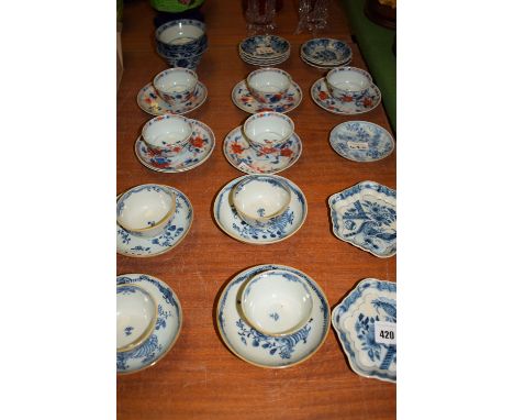 A quantity of Chinese export blue and white tea bowls and saucers; two blue and white teapot stands; three small blue and whi