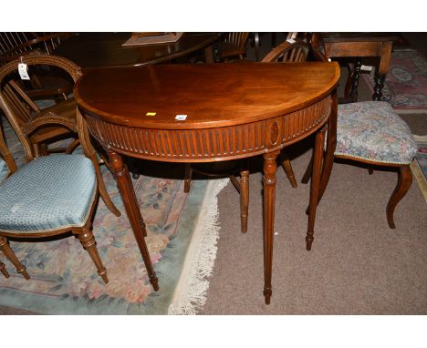 A reproduction inlaid mahogany console table with fluted frieze, raised on turned legs; together with a cane conservatory cha