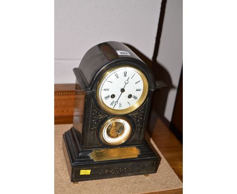 A mantel clock in slate case, white enamel roman dial above barometer and presentation plaque.