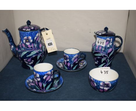 A Maling coffee service for two, cornflower decoration on mottled blue ground, comprising: coffee jug, covered cream jug, two