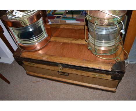 A stained wood metal bound galvanized trunk fitted carrying handles to sides and front.