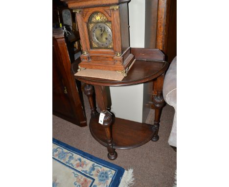 A two-tier console table, raised on turned fluted legs.