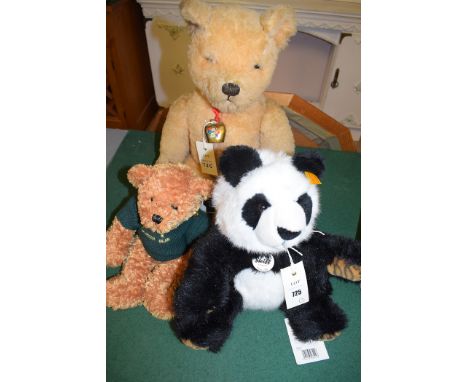 A Channel Island Gurkha bear with green jumper; together with a Steiff black and white panda bear titled 'Manschly'; and a la