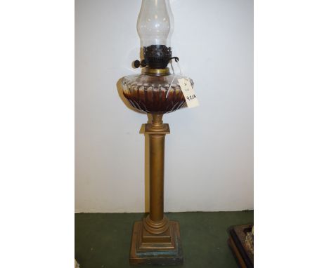 A late 19th/early 20th Century brass oil lamp, with clear cut glass reservoir.